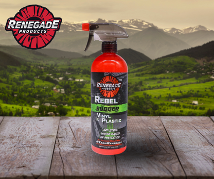 Spray bottle of Renegade Rebel Rubber, Vinyl & Plastic Detailer on a vehicle dashboard with clean, restored trim in the background.